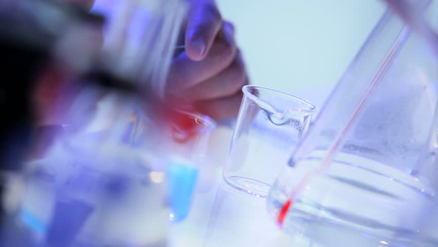 Hands male Caucasian scientific researcher testing vaccines on glass slides close up