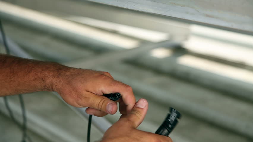 Close up of the man working on solar panels