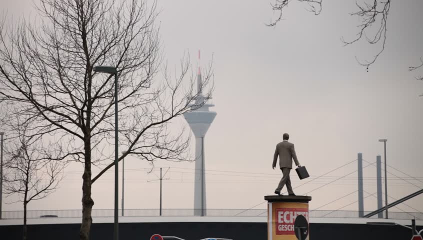 DUSSELDORF, GERMANY â FEBRUARY 28: The Businessman statue by Christoph PÃ¶ggeler is a symbol of the city present status as a powerful economic center.  February 28, 2013,  DÃ¼sseldorf, Germany
