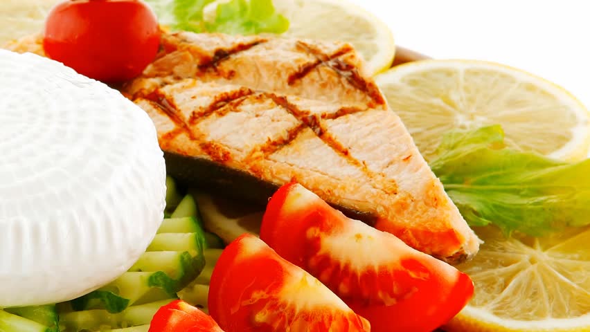 image of salmon with lemon and tomatoes on wood