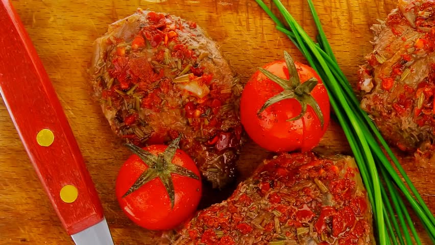 spicy meat on wood with pepper and chives
