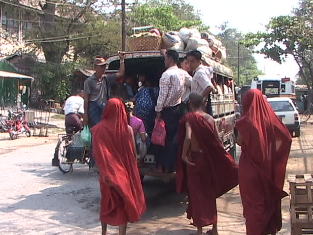 burma scenes: monks and other get on truck taxi