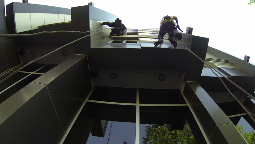 Industrial Climbers - Facade Cleaning - Time Lapse.
Window cleaners outside of an office building hanging from a rope. HD1080p.