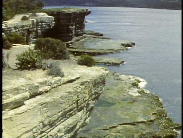 Seacliff, rugged rocks, South shore, medium wide, tilt up, Tasmania, Australia