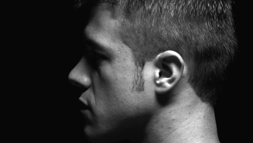 Close up of man's profile in black and white. Experimental lighting.
