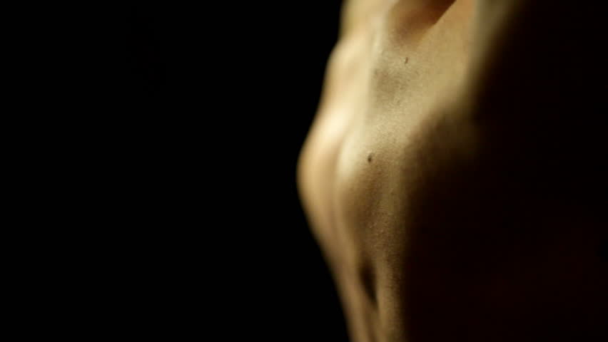 Young man doing weightlifting of shoulder muscles at home. Close-up of his muscles while lifting. High Quality.