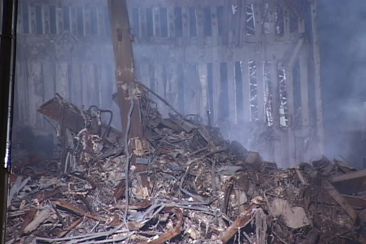 NEW YORK CITY - SEPTEMBER 28, 2001: Pile of rubble with smoke rising in front of remains of World Trade Center structure.