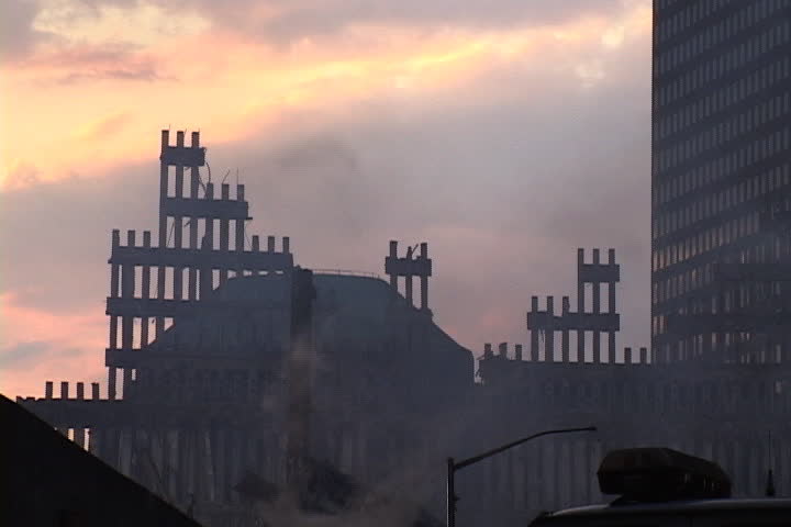 NEW YORK CITY - SEPTEMBER 28, 2001: Silhouette of World Trade Center remains against sunset. Smoke rising from rubble.