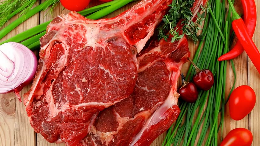 fresh meat : raw beef spare ribs with thyme red chili pepper garlic dill and cherry tomato on wooden board 1920x1080 intro motion slow hidef hd