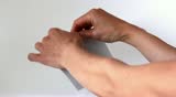 Hands tear apart piece of paper. Torn strip of paper
