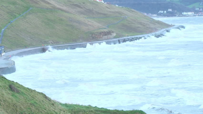 Coastline being battered by rough seas and waves.