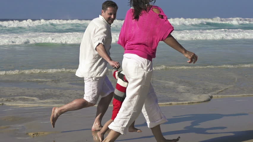Happy family having fun on the beach, super slow motion, shot at 240fps
