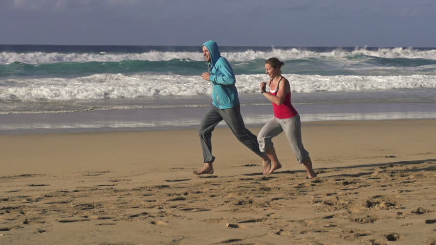 Couple jogging, race on the beach, super slow motion, shot at 240fps
