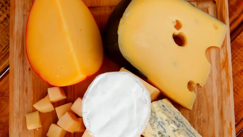 different cheeses served on wooding cutting board 1920x1080 intro motion slow hidef hd