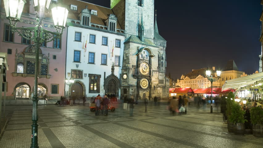 PRAGUE - APRIL 2, 2009: Tourists are walking and watching Astronomical clock. In spite of Global crisis the tourists are steadily each hour collecting to watch Apostles performance on Old Town tower.