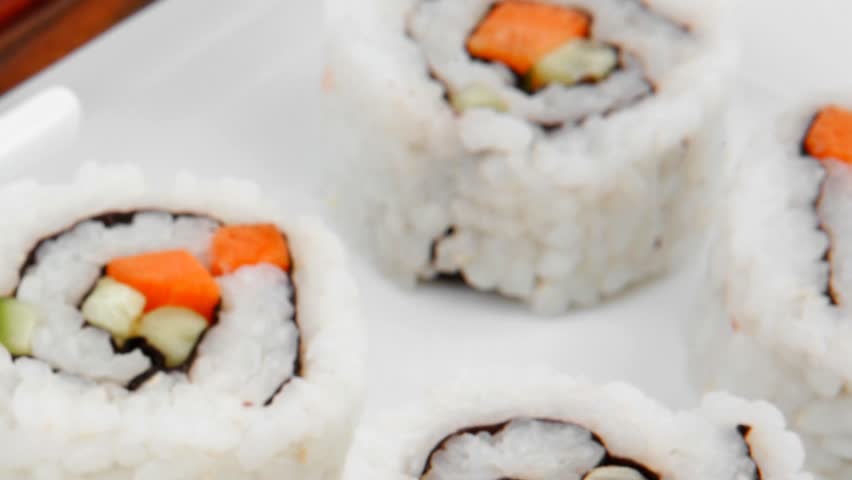 Maki Sushi - California Maki Roll made of fresh raw Salmon Cream Cheese and Avocado inside. Served with wasabi . Isolated on square plate 1920x1080 intro motion slow hidef hd