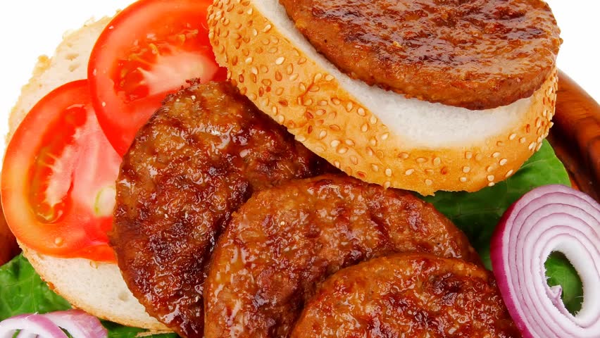 several large roast hamburger with loaf on wooden plate 1920x1080 intro motion slow hidef hd