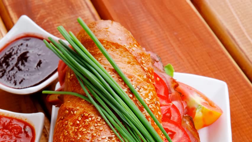sandwich : fresh french white baguette with chicken smoked sausage on ceramic plate over wooden table 1920x1080 intro motion slow hidef hd