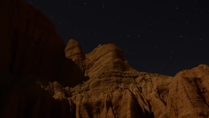 Astrophotography Time Lapse Moonshadow across Sandstone Tilt Down