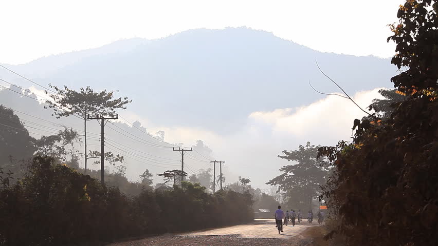 VANG VIENG - CIRCA MARCH, 2011:children go to school on the road. Vang Vieng, Laos.
