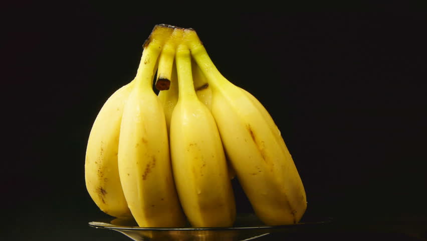 Bunch of bananas rotating on black background