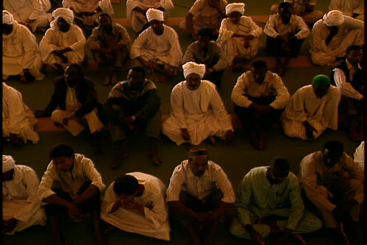 KHARTOUM, SUDAN, AFRICA - DECEMBER 01, 1998: MS high angle many Muslim men seated on floor of mosque.