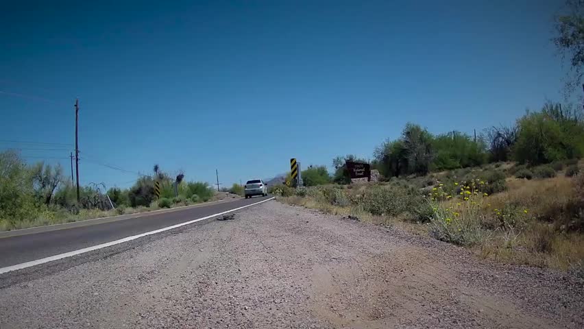 Fast time-lapse of mountain drive to a canyon lake in Arizona. Man smiles in satisfaction at end. These basins are rare in a state with 0% freshwater.