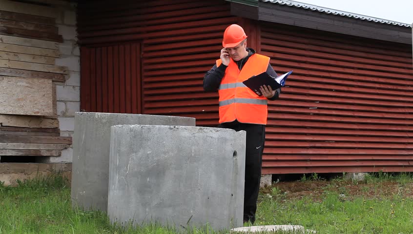 Building inspector with a folder near unfinished house episode 1