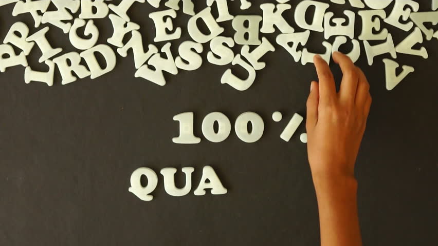 A person spelling 100 percent quality