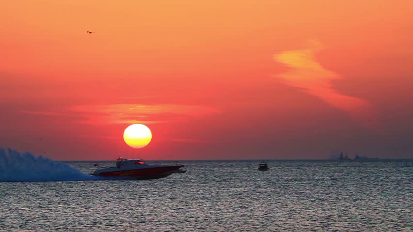 Power boat speeding up into Marmara Sea on sunset. Big water spray
