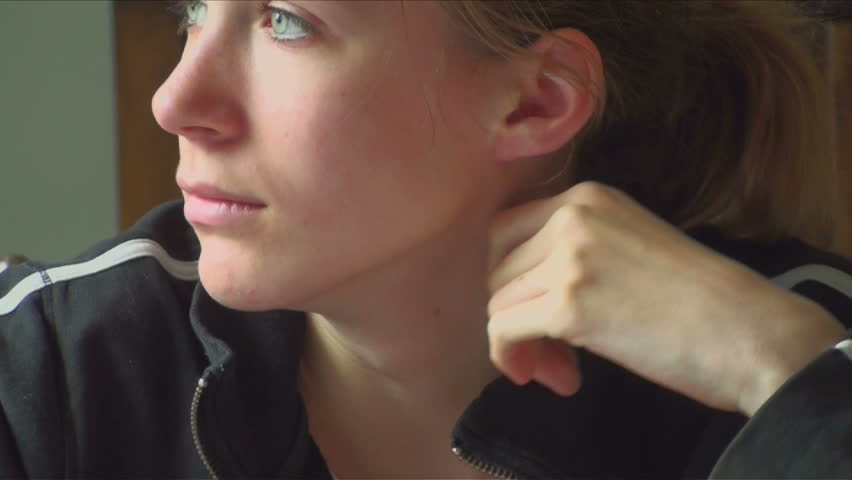 Emotions flicker across beautiful teenage girl's face.