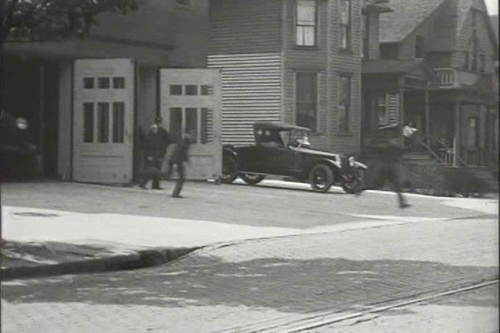 1910s, 1920s - Fire trucks and horse drawn fire vehicles race to put out fires