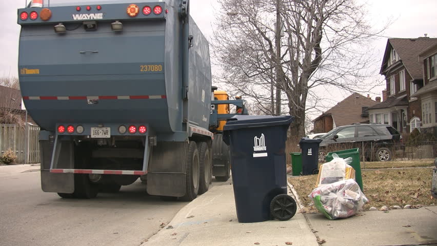 TORONTO - APRIL 22: Truck picking up recyclables, Toronto, Canada, April 22nd, 2009. Large blue bins are used for recycling cardboard and glass at all single-family households in Toronto.