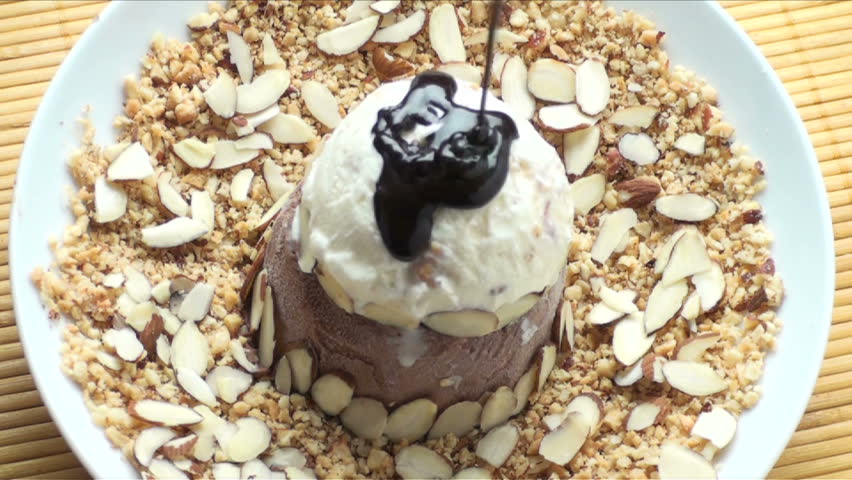 1920x1080 Hot fudge poured over ice cream, decorated with almond slivers 