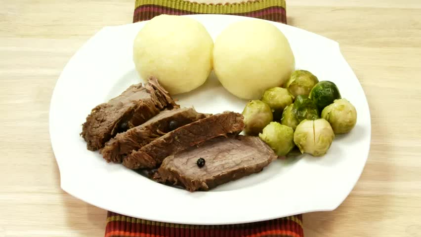Beef meat with brussel sprouts on a plate.
