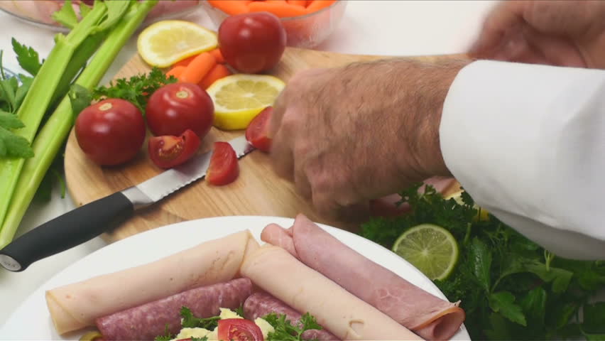1920x1080 Chef rolls slices turkey, ham, salami, arranges on pate, creates party platter. 