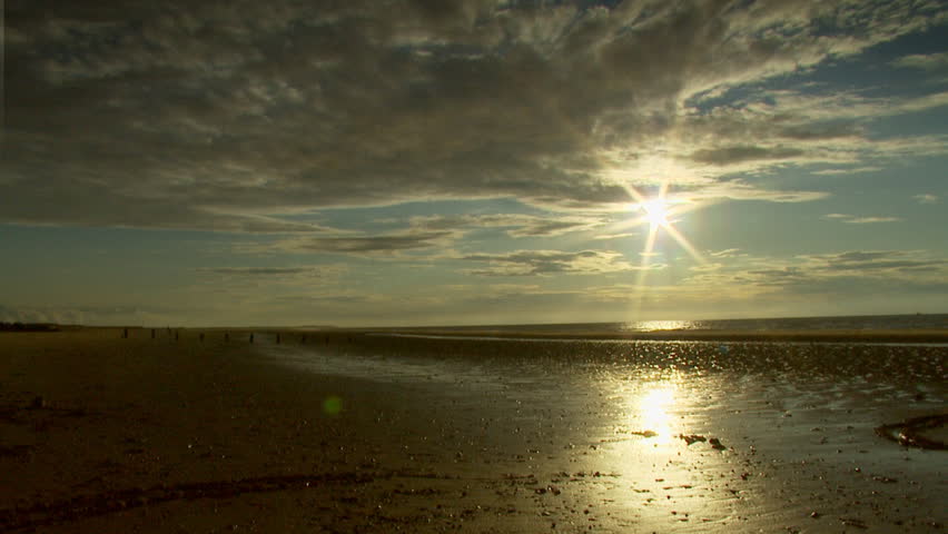 Time lapse of moving sun and water in the evening 