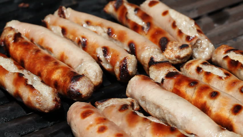 Sizzling sausages on a bbq grill