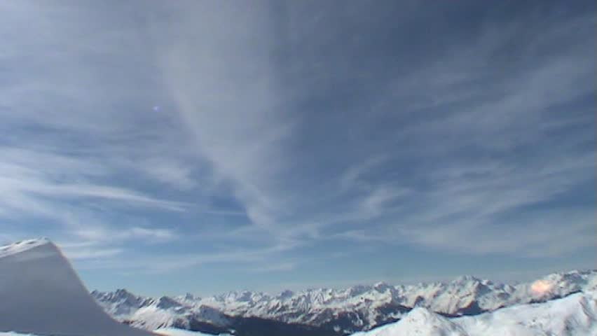 Snowboarder jumping over kicker 