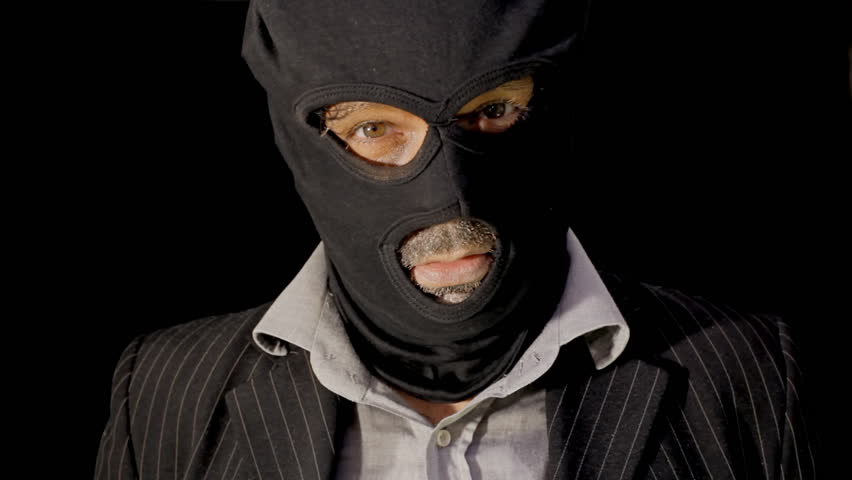 A Masked Man Robber Criminal Suddenly Appears From Deep Darkness And Ominously Shows His Gun