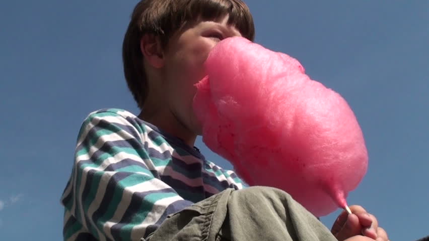 young boy eating cotton candy