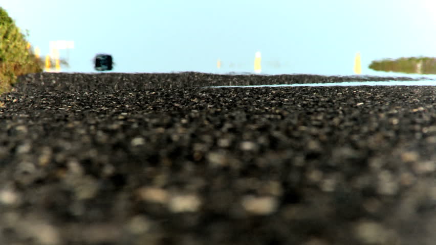 Traffic & heat reflection on a tarmac countryside road