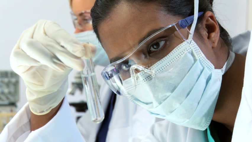 Close up of female scientist examines a test tube