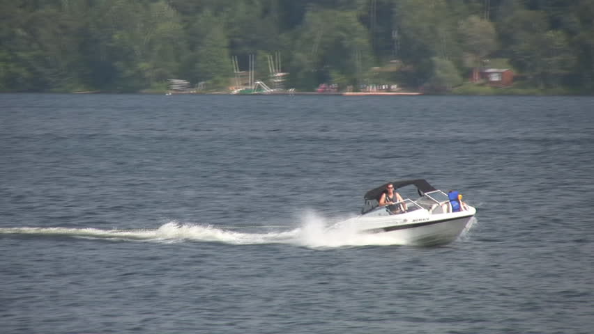 PETERBOROUGH, CANADA - AUGUST 22: Boat pulls boys riding an inner tube, August 22, 2009, Peterborough, Canada. Consumer advocacy groups have focused on tubing safety in recent years.