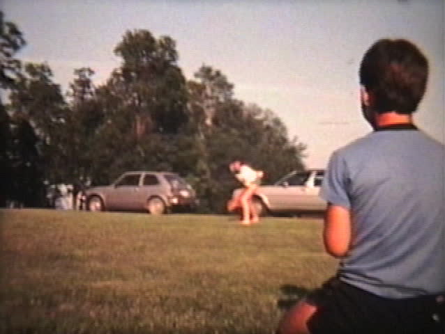 A man experiments with throwing a curve ball pitch to his young nephew during the summer of 1982.