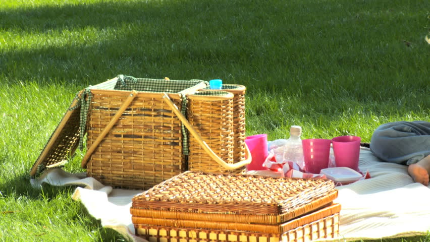 Young caucasian family enjoying time out together with a picnic on a summers day