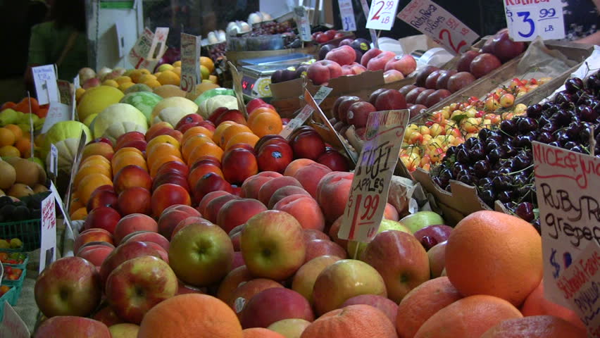 Food transaction at a colorful produce market. HD 1080i