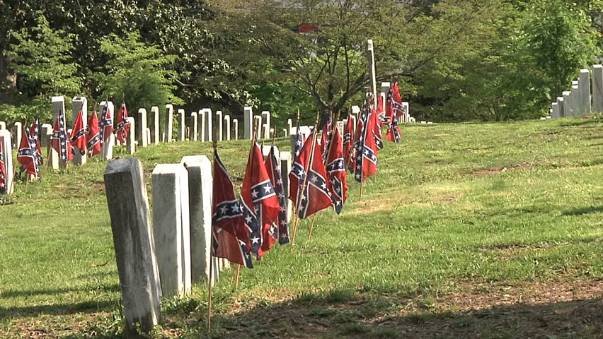 Confederate graves decorated with small Confederate battle flags.