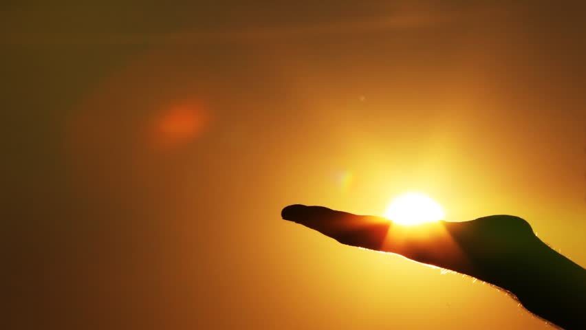 the hand catches the sun in a fist 