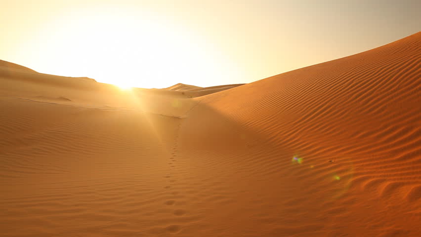 pan shot over beautiful sand dunes in sunset